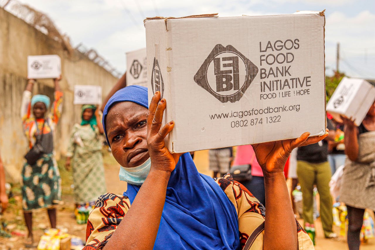 services-02 Community members engage in food distribution at Lagos Food Bank initiative event.